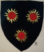 Device: Sable, three suns Or eclipsed Gules